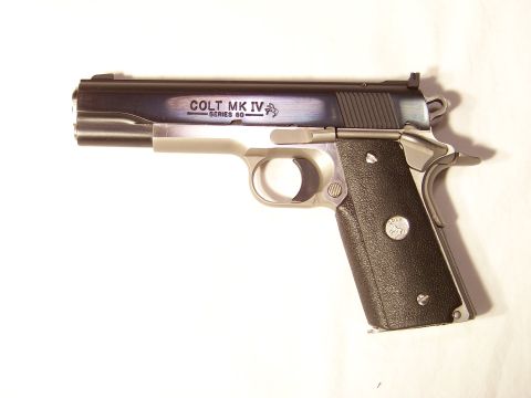 1995 Mercury Grand Marquis - A close-up view of a Colt MK IV Series 80 pistol against a white background.