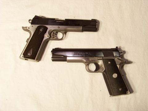 1995 Mercury Grand Marquis - Two semi-automatic pistols are displayed on a white background.