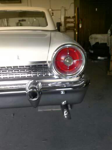 1960 Ford Falcon - Rear view of a white 1960 Ford Falcon with a chrome bumper and a visible exhaust pipe.