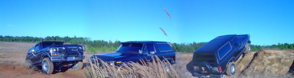 Black lifted SUV shown three times across a grassy off-road field under blue sky
