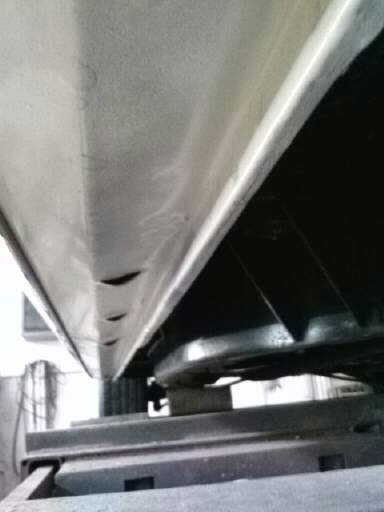 1960 Ford Falcon - Close-up view of the rocker panel and undercarriage of a vehicle, showing structural components.
