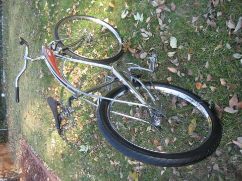 1994 Ford Bronco - A vintage bicycle with a chrome frame and red tank rests on the grass.