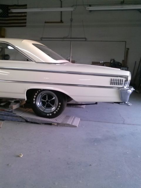 1960 Ford Falcon - Rear view of a 1963 Ford Galaxie with custom wheels and tires, parked inside a garage.
