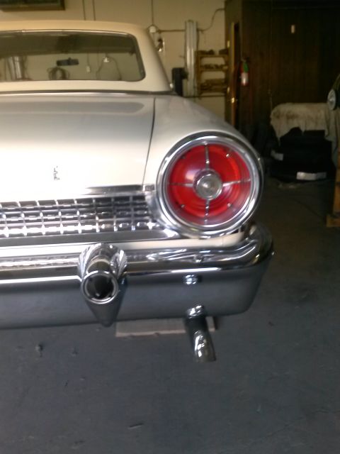 1960 Ford Falcon - Rear view of a white 1959 Ford Fairlane with chrome bumper and round taillight.