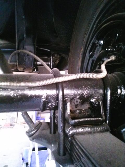 1960 Ford Falcon - Close-up view of the rear axle and suspension components of a vehicle.