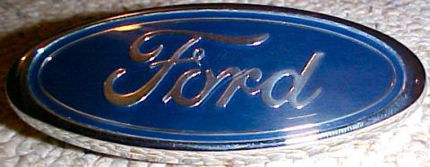 2003 Ford Expedition - Close-up of a Ford oval emblem, likely a vehicle badge.