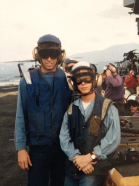 1995 Ford Bronco - Two people in flight suits and helmets pose on the deck of an aircraft carrier.