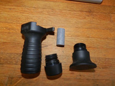 1996 Ford Bronco - Disassembled gun grip accessory parts are shown on a wooden floor.