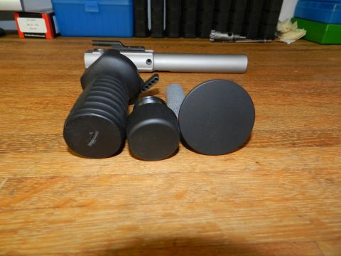 1996 Ford Bronco - Various gun components, including a grip and barrel assembly, are laid out on a wooden surface.