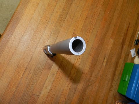 1996 Ford Bronco - A close-up view of a gun barrel resting on a wooden table, with cleaning supplies nearby.