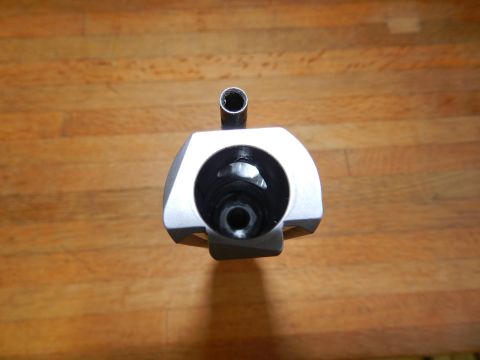1996 Ford Bronco - A close-up view of a metallic component with a hollow center, set against a wooden background.