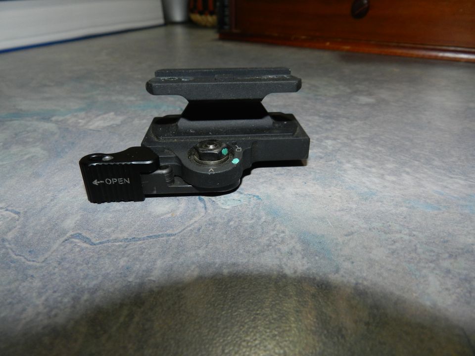 Black camera flash bracket with an 'OPEN' lever and adjustment dial