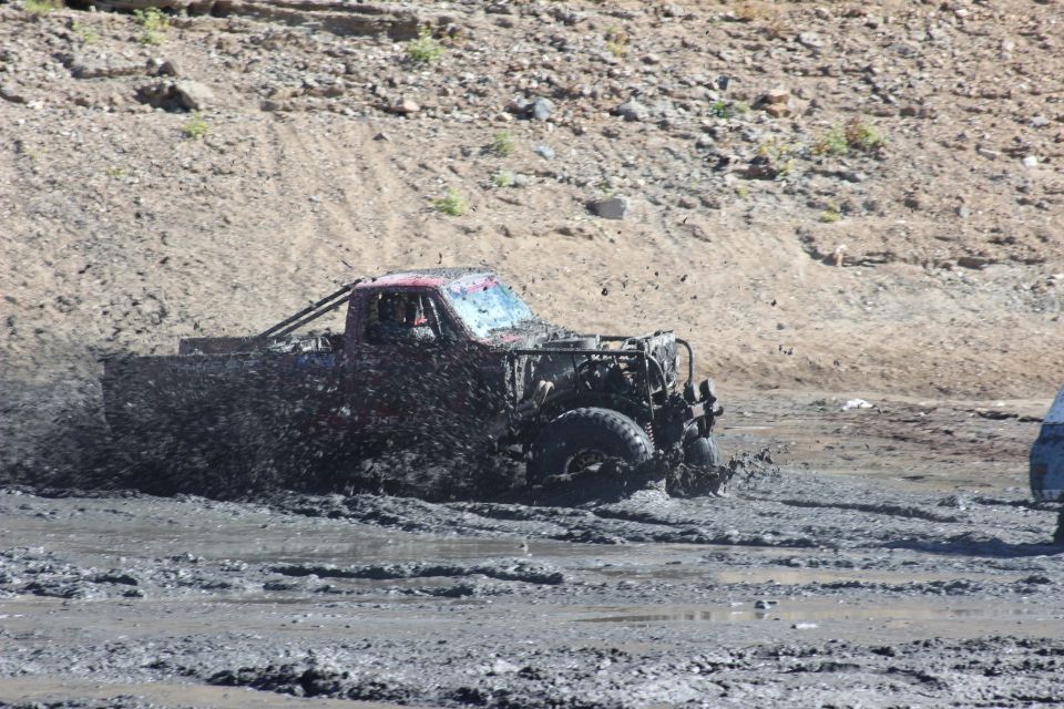 Muddy truck in a mud bog, front view