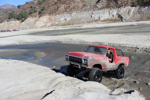 1978 Ford Bronco - This red 1978 Ford Bronco navigates a muddy, watery terrain.