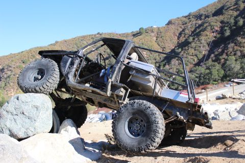 1978 Ford Bronco - Custom off-road buggy navigating a rocky trail with a clear blue sky.
