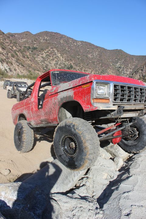 1978 Ford Bronco - This modified 1978 Ford Bronco navigates a rocky trail with its large off-road tires.