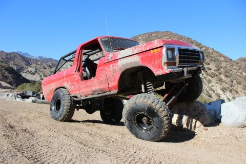 1978 Ford Bronco - This modified 1978 Ford Bronco navigates a challenging rocky course under a clear blue sky.