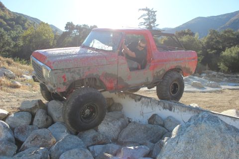 1978 Ford Bronco - Mud-covered 1978 Ford Bronco navigates a challenging rock course.