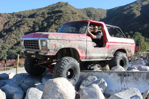 1978 Ford Bronco - This red SUV, likely a Ford Bronco from the late 1970s, navigates a rocky obstacle course.