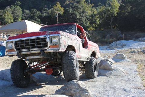 1978 Ford Bronco - This mud-covered 1978 Ford Bronco is shown off-roading on a rocky path.