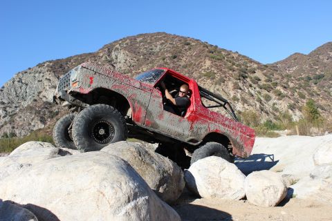 1978 Ford Bronco - This red 1978 Ford Bronco is shown tackling a rocky trail with a driver behind the wheel.