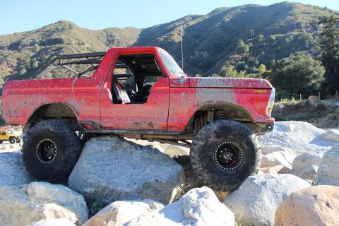 1978 Ford Bronco - Modified 1978 Ford Bronco navigating a rocky trail with a second vehicle visible.