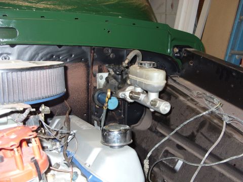 1967 Ford F-250 - The master cylinder and air cleaner assembly are visible in the engine bay of a vehicle.