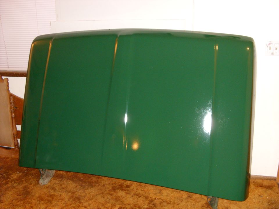 Green truck hood resting on supports