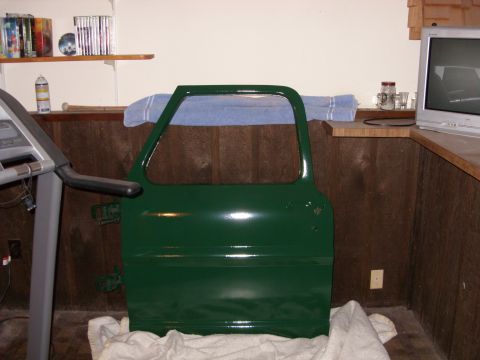 1967 Ford F-250 - A single green vehicle door is shown indoors, resting on a white cloth.