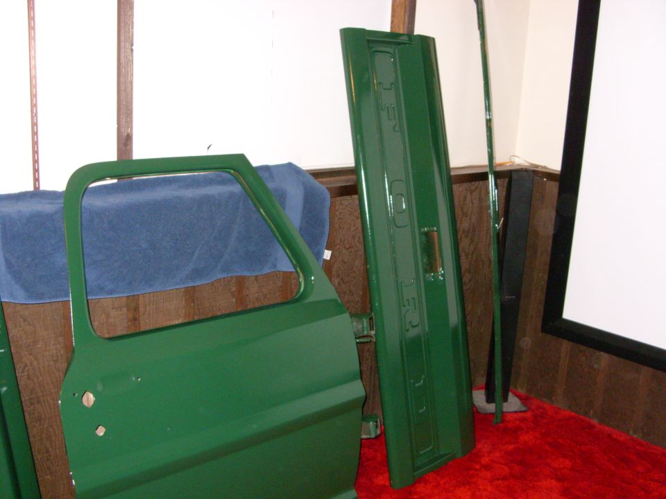 Green truck door and tailgate with "FORD" embossed on the tailgate
