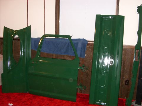 1967 Ford F-250 - Green painted truck door, fender, and tailgate panel are displayed indoors.