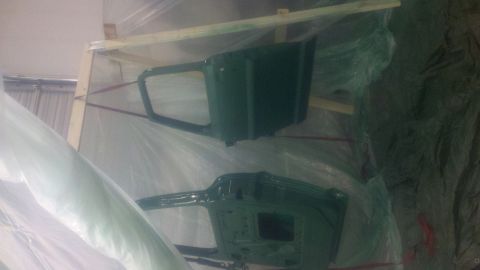 1967 Ford F-250 - Two green truck cab doors are prepared for painting, covered in protective plastic.