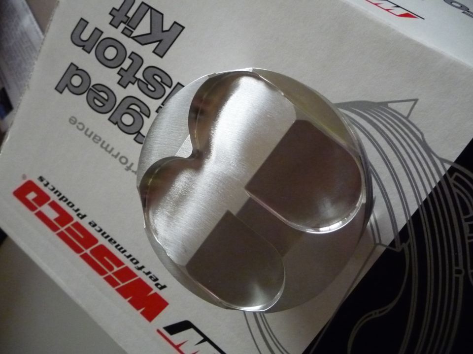 Wiseco forged piston on a box with text 'Forged Piston Kit' and 'Performance Products'