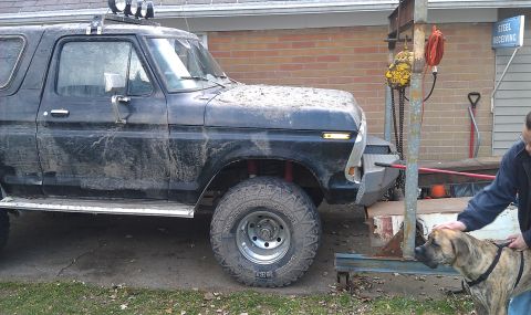 1979 Ford Bronco - Mud-covered 1978 Ford Bronco with a custom bumper and auxiliary lights on the roof.