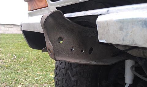 1979 Ford Bronco - This is a close-up view of a vehicle's front bumper section, showing its condition and mounting points.