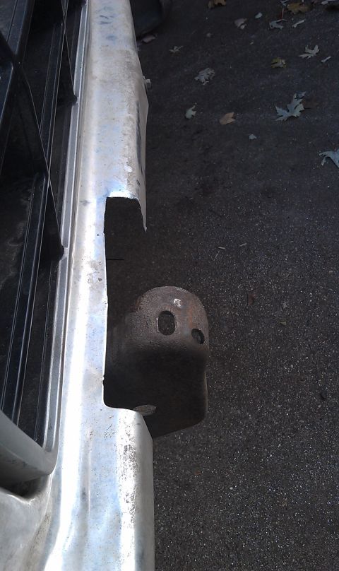 1979 Ford Bronco - Close-up of a vehicle's front bumper and tow hitch receiver, with a portion of the grille visible.