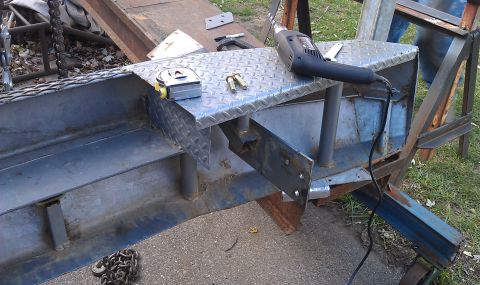 1979 Ford Bronco - A close-up of metal parts and tools, suggesting ongoing construction or repair work.