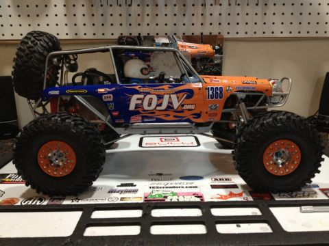 1986 Ford Bronco - This RC rock crawler features a striking orange and blue flame livery with the number 1368 prominently displayed.