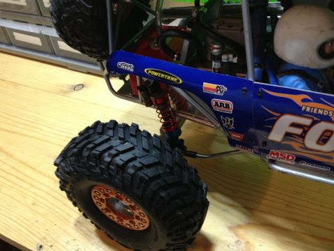 1986 Ford Bronco - Close-up of a remote control rock crawler model, showing its suspension and tires.