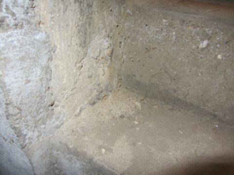 1968 Ford Mustang - The photo shows a textured concrete corner with visible imperfections and discoloration.