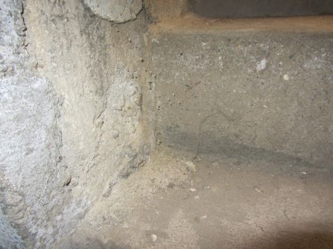 1968 Ford Mustang - A close-up view of a rough concrete corner, showing texture and discoloration.