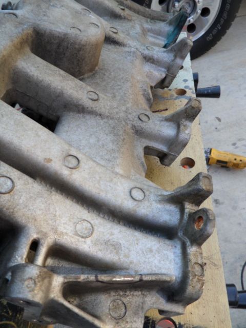 1994 Jeep Cherokee - Close-up view of an aluminum intake manifold, showing its intricate design and bolt hole patterns.