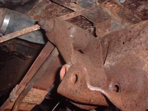 1993 Ford Bronco - Undercarriage view of heavily rusted suspension parts and exhaust system.