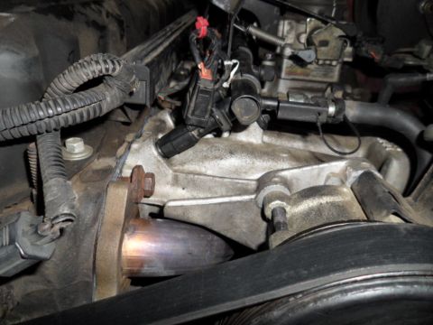 1994 Jeep Cherokee - Engine components are visible in this close-up shot, showing a metal pipe and wiring.