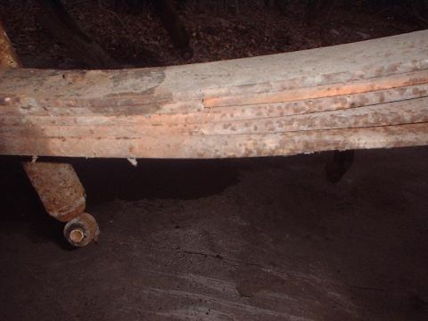 1993 Ford Bronco - Close-up of heavily rusted leaf springs, likely from an older vehicle.