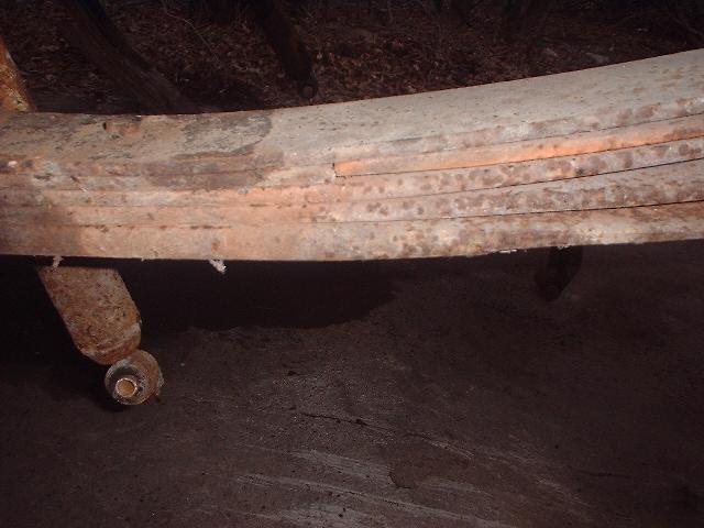 rusted leaf springs with a bracket and bolt