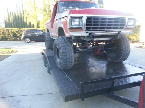 1978 Ford Bronco - This lifted 1979 Ford F-Series truck is shown from the front while loaded onto a trailer.