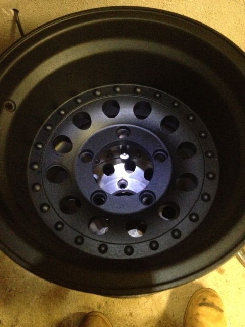1996 Ford F-150 - Close-up view of a black aftermarket wheel, likely for a truck or SUV.