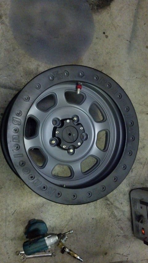 2008 Jeep Wrangler - Wheel and tire assembly with tools on the ground.