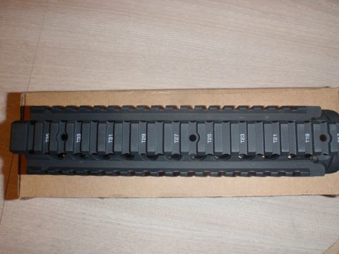 2000 Dodge 1500 - A close-up view of a black tactical rail system with various numbered slots for attachments.